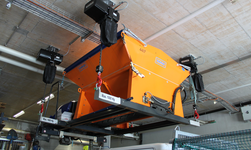 Electric chain hoists lift salt spreading barrel over people