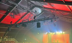 The tent infrastructure includes a modern rigging system for lighting and sound