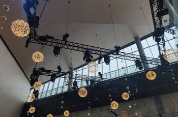 Electric chain hoists carry trusses with lighting