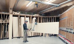Transport of wooden panels with sheet material grab