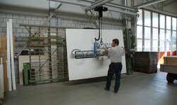 Transporting a wooden panel with a vacuum lifter