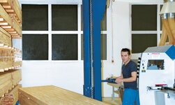 Shelf storage operation unit with electric chain hoist lifts stacks of timber