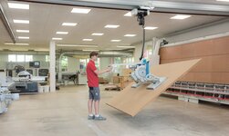 Transporting a wooden panel with a vacuum lifter