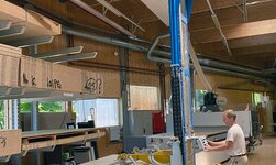 The wooden boards are lifted out of the cantilever rack with the storage and retrieval device