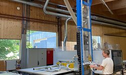 Wooden panel is placed on work table of Nesting CNC-controlled work centre
