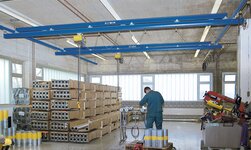Suspended crane with electric chain hoists lift steel pipes
