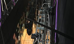 Climbing hoists hold truss with loudspeaker and spotlight