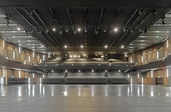 The concert hall with the basic framework of the rigging system with electric chain hoists and motor trolleys