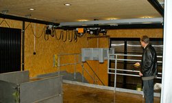 A plastic container is gently lifted by the GIS electric chain hoist and transported from the ground floor to the stage on the ground floor.