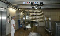 A radio-controlled stainless steel underslung travelling crane is used to transport cheese loaves