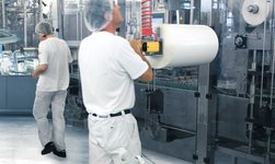 In the chemical plant, a roll is moved into the machine with a telescopic chain hoist
