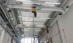 Underslung travelling crane with several crane girders The electrically driven crane system is operated by radio control
